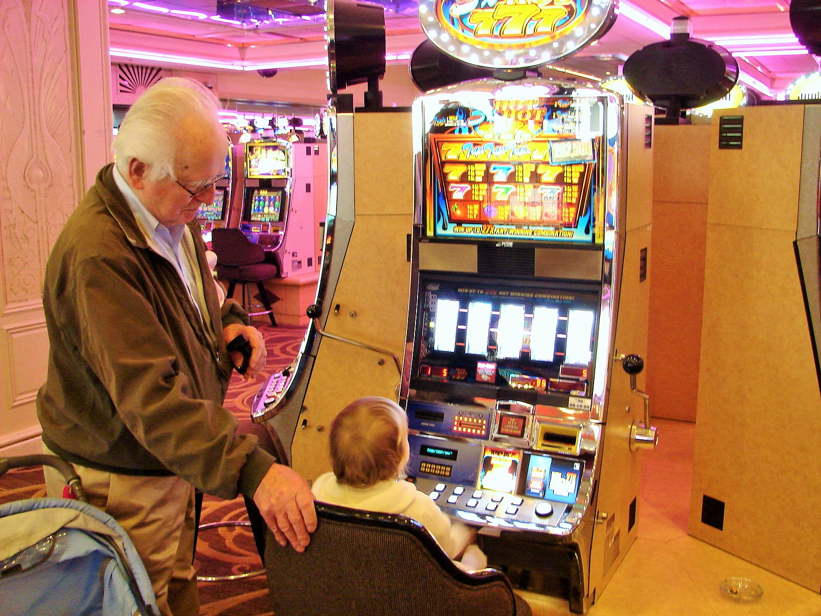 Maureen at slot machine with grandpa in Las Vegas.