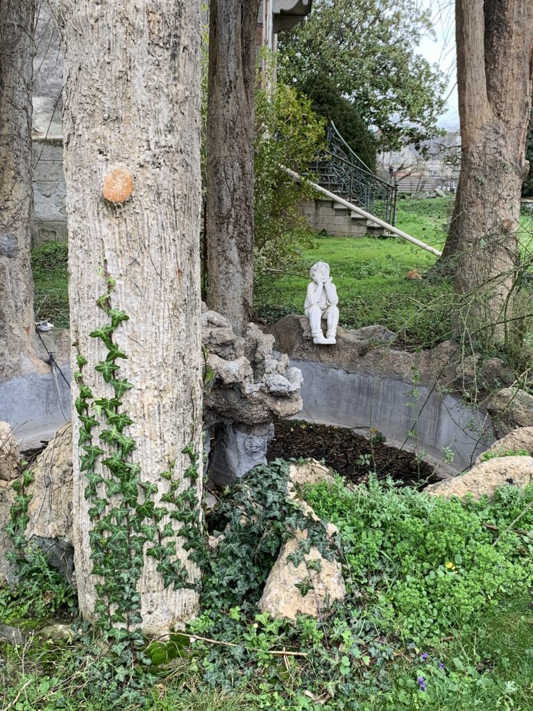 Boy Statue underneath the treehouse.