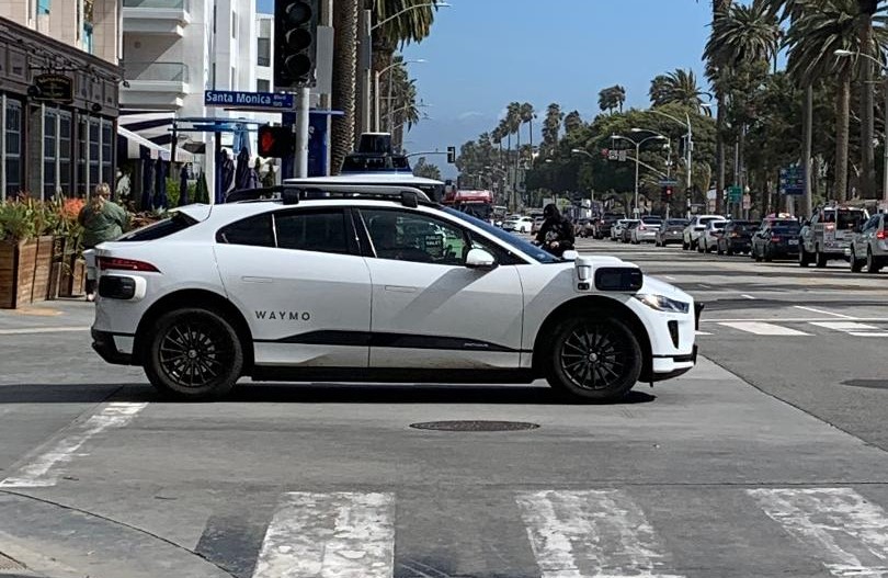 Waymo driverless car with a driver